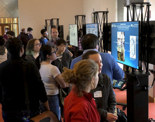 People talking and networking during digital posters session