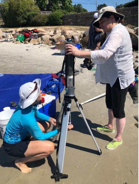 Dr. Heidi Nepf of the MIT Department of Civil and Environmental Engineering and Dr. Julie Simpson of MIT Sea Grant working on extruding and slicing a sediment core at the field site.